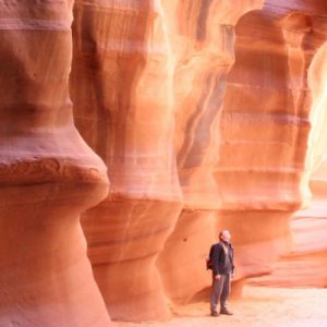 a man marveling at rock formations somewhere in Antelope Canyon