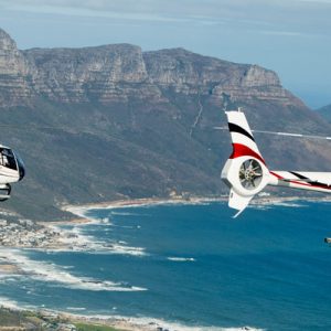 two helicopters flying around Cape Town