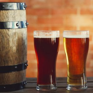4 glasses of beers and a small barrel to the left