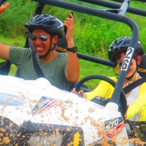 a man and women on a buggy on an off-road somewhere in Guam