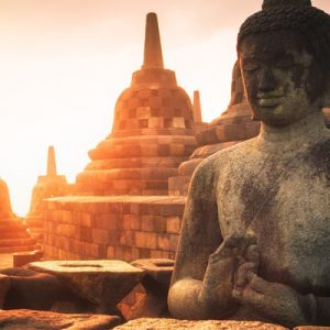 sunrise at Borobodur Temple with a close up of a Buddhist statue