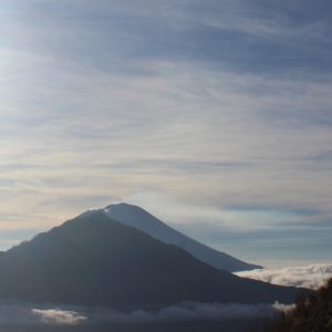 silhouette of hikers atop mount batur