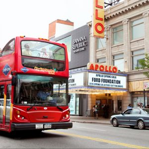 red double decker bus with tourists on board
