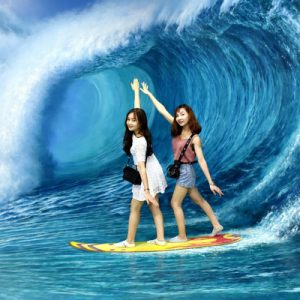 tourists pose like surfers