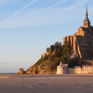 a view of Mont-Saint-Michel and its abbey from the beach