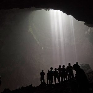 tourists posing inside jomblang cave