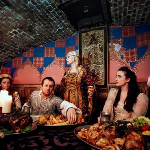 knights and people dining at medieval banquet