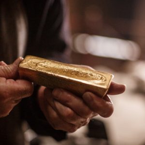man holding gold bar