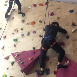 three people climbing up wall during bouldering in double 8 taipei