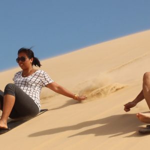 two people sandboarding in port stephens