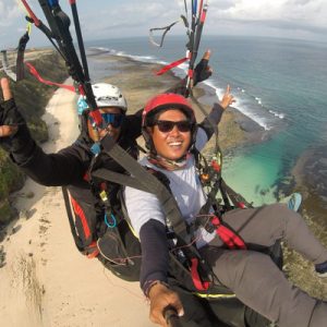 woman paragliding over timbis beach
