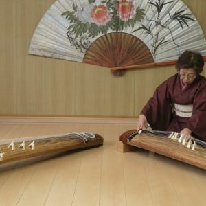 two women in kimonos playing the koto